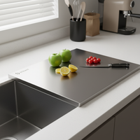 Close-up of a premium food-grade stainless steel cutting board on a minimalist kitchen counter.